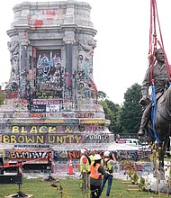 The huge statue of Confederate Gen. Robert E. Lee is carefully lowered to the ground by workers, where it was cut in half for transport by truck to state storage. Gov. Ralph S. Northam had ordered the state-owned statue to come down in July 2020, but court challenges held up its removal until Sept. 8, 2021.