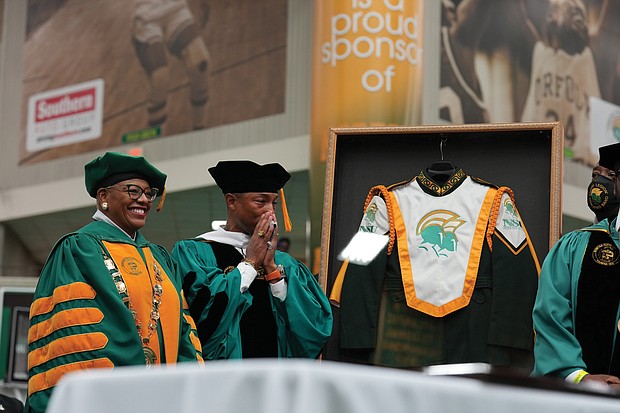 Award-winning musician and Virginia Beach native Pharrell Williams is overcome with emotion Dec. 11 as he is made an honorary member of the Norfolk State University Spartan Legion Marching Band and presented with a framed band uniform by NSU President Javaune Adams- Gaston. Mr. Williams delivered the commencement address to the university’s fall graduates. He also was awarded an honorary doctorate during the ceremony at NSU’s Joseph G. Echols Hall.