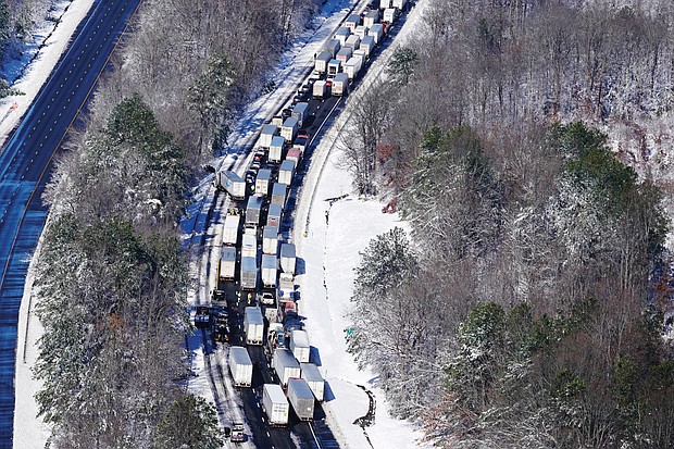 Drivers stranded on Interstate 95 wait for hours Tuesday for icy roadways, accidents and disabled vehicles to be cleared in Carmel Church. Roughly 50 miles of I-95 from Caroline County to Prince William County were shut down Monday until 8:30 p.m. Tuesday, with vehicles stuck overnight on the interstate.