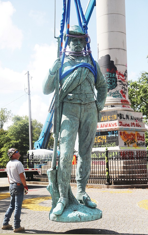 Erected in 1894, the Confederate Soldiers and Sailors Monument in Libby Hill Park is taken down on July 8, 2020, along with other city-owned Confederate statues.