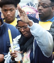 Milton Thompson, left, and Monique Mines-Talley, the parents of 17-year-old Eumiyah Thompson, attend a vigil celebrating the life of their daughter who was shot and killed Dec. 18 while on her front porch of the family’s apartment in Gilpin Court as she was talking with a friend. Her friend was wounded by the gunfire. Eumiyah was a senior at Spartan Academy on West Leigh Street and was expected to graduate in June, her mother said. “That was my baby,” Ms. Mines-Talley said at the vigil held Dec. 27 in Gilpin Court. It was organized by Charles D. Willis, executive director of United Communities Against Crime. Prayers and candles were part of the somber ceremony.