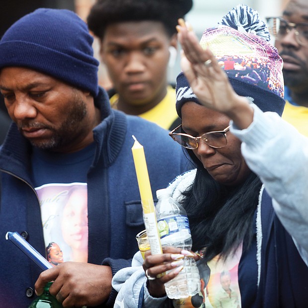 Milton Thompson, left, and Monique Mines-Talley, the parents of 17-year-old Eumiyah Thompson, attend a vigil celebrating the life of their daughter who was shot and killed Dec. 18 while on her front porch of the family’s apartment in Gilpin Court as she was talking with a friend. Her friend was wounded by the gunfire. Eumiyah was a senior at Spartan Academy on West Leigh Street and was expected to graduate in June, her mother said. “That was my baby,” Ms. Mines-Talley said at the vigil held Dec. 27 in Gilpin Court. It was organized by Charles D. Willis, executive director of United Communities Against Crime. Prayers and candles were part of the somber ceremony.