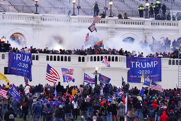 Rioters on the West Front at the U.S. Capitol on Jan. 6, 2021, in Washington, and now, there are fourteen recommended reads about the January 6.
	John Minchillo/AP