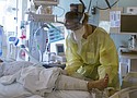 A nurse cares for a critically ill patient in the Intensive Care Unit at Oregon Health and Science University.  The number of people hospitalized with COVID-19 increased to 692 statewide this week, but hospitalizations were still about 40% below their peak during a summer surge. (Photo courtesy OHSU)