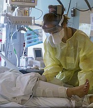 A nurse cares for a critically ill patient in the Intensive Care Unit at Oregon Health and Science University.  The number of people hospitalized with COVID-19 increased to 692 statewide this week, but hospitalizations were still about 40% below their peak during a summer surge. (Photo courtesy OHSU)