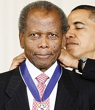 President Obama presents Sidney Poitier with the Presidential Medal of Freedom in August 2009.