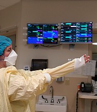 Four states have less than 10% remaining capacity in their ICUs: Kentucky, Alabama, Indiana and New Hampshire, according to data from the US Department of Health and Human Services, and pictured, a nurse suits up in Lebanon, New Hampshire, on January 3.
Mandatory Credit:	Steven Senne/AP