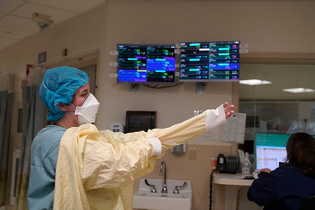 Four states have less than 10% remaining capacity in their ICUs: Kentucky, Alabama, Indiana and New Hampshire, according to data from the US Department of Health and Human Services, and pictured, a nurse suits up in Lebanon, New Hampshire, on January 3.
Mandatory Credit:	Steven Senne/AP