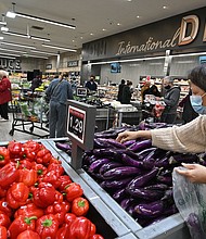 Polls indicate voters are every bit as concerned about the economy as they are about the pandemic. And they feel the government is not doing enough to fight inflation, and pictured, people shop for groceries at a supermarket in Glendale, California, on January 12.
Mandatory Credit:	Robyn Beck/AFP/Getty Images