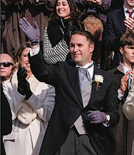 Jason Miyares waves to the crowd after he is sworn in as Virginia’s first Latino attorney general.