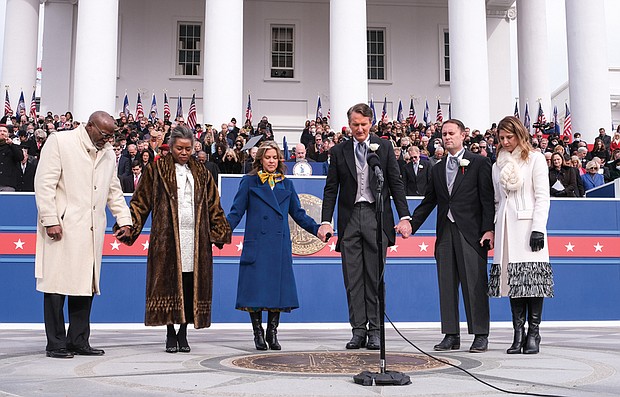 Newly sworn-in Gov. Glenn A. Youngkin, third from right, caps off last Saturday’s inaugural ceremony with a prayer for the Commonwealth he delivered with his fellow GOP top office holders and their spouses. They are, from left, Terence Sears, and his wife, Lt. Gov. Winsome Earle-Sears; First Lady Suzanne youngkin; Attorney General Jason Miyares and his wife, Page Atkinson Miyares. Below, The Virginia union university Choir performs on the steps of the Capitol during the inaugural ceremony. The choir also had been invited by Gov. Glenn A. youngkin to perform with the Richmond Symphony at the inauguration’s Spirit of Imagination Candlelight Dinner last Friday at the Science Museum of Virginia. The choir is under the direction of David Bratton and Assistant Director Joel Lester.
