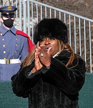 Shirley Green of Fredericksburg stands and applauds following the a cappella rendition of the national anthem performed by state Delegate Christopher T. Head of Botetourt County and Sen. John A. Cosgrove Jr. of Chesapeake.