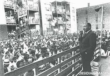 Dr. Martin Luther King Jr. addresses residents in an alley behind an apartment building on Chicago’s West Side. King came to Chicago in 1966 to
challenge slum conditions and racist policies. This historic moment was
captured by legendary photographer John Tweedle, the first African American photographer to be hired by a major metropolitan daily newspaper.
This and other rare photos of King taken by Tweedle are being offered
as NFTs by the Obsidian Collection to be sold in the NFT marketplace.
Obsidian Images.