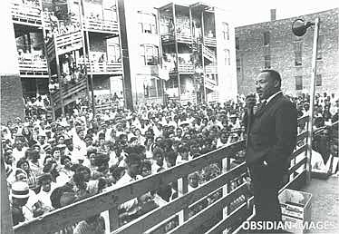 Dr. Martin Luther King Jr. addresses residents in an alley behind an apartment building on Chicago’s West Side. King came to Chicago in 1966 to
challenge slum conditions and racist policies. This historic moment was
captured by legendary photographer John Tweedle, the first African American photographer to be hired by a major metropolitan daily newspaper.
This and other rare photos of King taken by Tweedle are being offered
as NFTs by the Obsidian Collection to be sold in the NFT marketplace.
Obsidian Images.