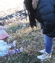 Zakiya Pollard of North Chesterfield attended the 5th Annual Prison Justice Rally last Saturday at Monroe Park with her daughter, 21-month-old Sanaa Pollard, who was there on her own agenda to explore the park and the remains of an overnight snowfall.