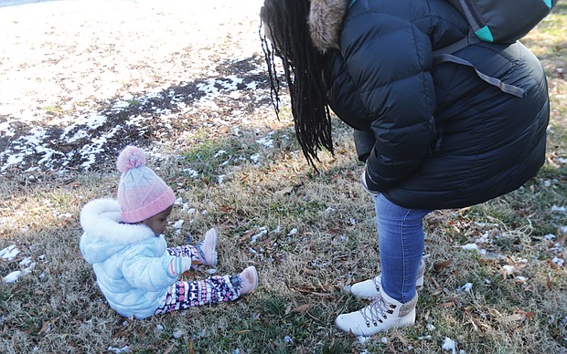 Zakiya Pollard of North Chesterfield attended the 5th Annual Prison Justice Rally last Saturday at Monroe Park with her daughter, 21-month-old Sanaa Pollard, who was there on her own agenda to explore the park and the remains of an overnight snowfall.