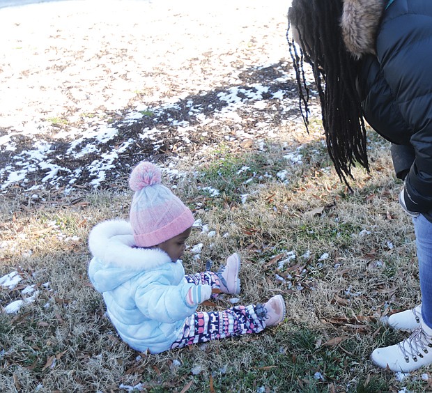 Zakiya Pollard of North Chesterfield attended the 5th Annual Prison Justice Rally last Saturday at Monroe Park with her daughter, 21-month-old Sanaa Pollard, who was there on her own agenda to explore the park and the remains of an overnight snowfall.