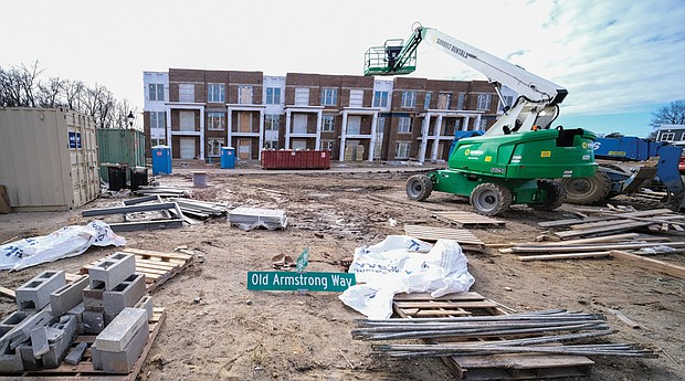 Armstrong Renaissance is heading to the finish line after more than three years of construc- tion at this East End site near the city’s border with Henrico County. Crews now are focusing on development of the final phase – 36 attached and detached homes to be sold at market rates – that will cap the redevelopment on the former site of Armstrong High School. 
Oversized compared with most of the homes on nearby streets, the new houses were initially priced between $225,000 and $350,000 and are designed to add a residential cachet to the area.
When finished, the total 22-acre development will contain 256 modern apartments and houses. The first residents moved in just before Thanksgiving in 2019.
Previously called Church Hill North, Armstrong Renaissance is the creation of a partnership of the Richmond Redevelopment and Housing Authority and the Boston-based nonprofit affordable housing developer, The Community Builders. The project is designed as the first step in the future redevelopment of the 30-acre Creighton Court public housing community located across Nine Mile Road.
The new units were used, in part, to relocate Creighton Court residents, clearing the way for a large chunk of the public housing community to be bulldozed and replaced with new units. Demolition of a major portion of Creighton Court is expected this year.
Mayor Levar M. Stoney and Richmond City Council cleared the way by allocating $6.8 million in federal American Rescue Plan Act funds to pay for new streets, alleys and underground utilities in the Creighton Court redevelopment.