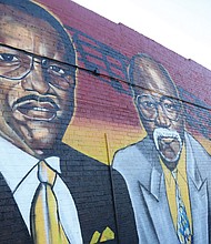 Sir James Thornhill puts the finishing touches on his latest mural, a salute to the founders of the storied Regular’s Social Club in North Side.
Marking its 64th year, the private men’s club commissioned the Richmond artist to create this tribute to founders, from left, the late Robert L. Harvey Sr. and Raymond Eldridge, on the north wall of the club’s home at 2521 Chamberlayne Ave. The two men, fed up with the exclusionary practices of other private Black clubs, joined with friends to start a group for ordinary workers like themselves, Mr. Harvey being an employee of A.H. Robins Co. and Mr. Eldridge being a letter carrier. 
“They called it the Regular’s Club because it was just for regular guys,” said Jesse J. Harrison III, a 50-year member who has served as the treasurer for several decades and is a former board chair.
Established in 1959, the club started with members going to each other’s houses, Mr. Harrison said. The club moved into the Chamberlayne Avenue building around 1971, he said, first renting and then purchasing it.
The club has hosted parties on weekends for members and guests, but has scaled back to monthly events since the pandemic, Mr. Harrison said. The club currently has about 40 members, he said, with room for more. Dues are $45 a month, he said.
Mr. Thornhill said he was delighted to be called on to create the mural. He noted that social clubs have a long history in Richmond’s Black community and that he was proud to help call attention to a place that has been around so long.
“This is part of telling the full story of the community,” he said.