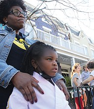 Tamara Ross and her daughter, Kori, 6, a kindergartener at Fox, view the damage to the school Saturday.