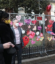 Gov. Glenn A. Youngkin, second from right, talks with school district and city officials late Monday afternoon after posting his own Valentine message on the fence outside Fox Elementary. With him are, from left, 2nd District City Councilwoman Katherine Jordan, 2nd District School Board Member Mariah L. White, Richmond Schools Superintendent Jason Kamras and Mayor Levar M. Stoney.