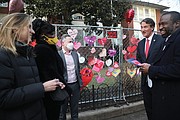 Gov. Glenn A. Youngkin, second from right, talks with school district and city officials late Monday afternoon after posting his own Valentine message on the fence outside Fox Elementary. With him are, from left, 2nd District City Councilwoman Katherine Jordan, 2nd District School Board Member Mariah L. White, Richmond Schools Superintendent Jason Kamras and Mayor Levar M. Stoney.