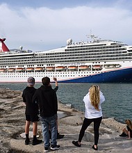 People watch as the Carnival Liberty cruise ship departs from Port Canaveral. Carnival Cruises will be relaxing its mask rules. A release from the company indicated masks will be recommended but not required on board from sailings departing on and after March 1.
Mandatory Credit: Paul Hennessy/SOPA Images/LightRocket/Getty Images