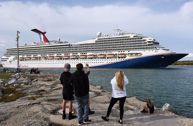 People watch as the Carnival Liberty cruise ship departs from Port Canaveral. Carnival Cruises will be relaxing its mask rules. A release from the company indicated masks will be recommended but not required on board from sailings departing on and after March 1.
Mandatory Credit:	Paul Hennessy/SOPA Images/LightRocket/Getty Images