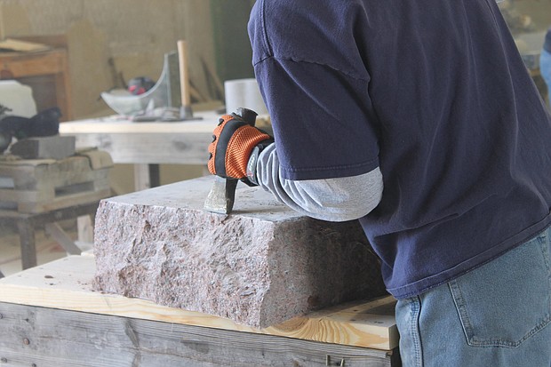 A stone cutter in Elberton, Georgia, uses a hammer and chisel to create the rough edges of a monument.
Mandatory Credit:	Courtesy Elberton Granite Association