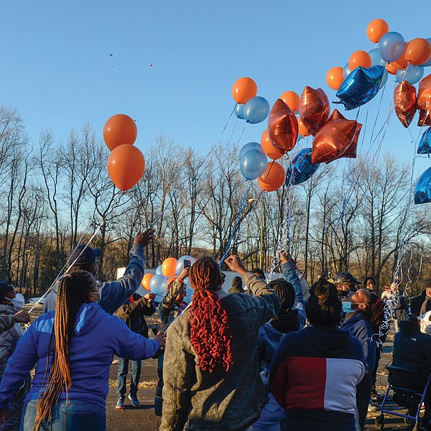 Family and friends of DaShawn “Da Da” Cox release balloons in memory of the 17-year-old Armstrong High School student who was shot and killed about 4:40 p.m. Feb. 17 outside the Ashley Oaks Apartments in the 1400 block of Jennie Scher Road in the East End. The teen’s mother and sister, as well as city officials, spoke at the vigil held last Sunday outside the apartment complex. 
“This is pain that I hope nobody out here will ever have to go through,” his mother, Berthenia Brown, told the crowd through tears. “It hurts.” 
Richmond Schools Superintendent Jason Kamras said he has been to so many vigils for slain young people that he has lost count. “I’m a little ashamed to say that, but it’s the truth.” He and others called for an end to gun violence in the city. 
“Enough is enough,” said 7th District School Board member Cheryl L. Burke, a retired principal. “You all tell us what to do.” 
A community meeting is scheduled for 6 p.m. Thursday, Feb. 24, at the Powhatan Community Center, 5051 Northampton St., to discuss possible solutions. Police are asking anyone with information about DeShawn’s death to call Richmond Police Major Crimes Detective A. Darnell at (804) 646-3927 or to contact Crime Stoppers at (804) 780-1000.