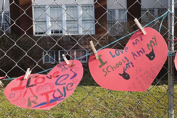 Hearts with handwritten notes adorn the fence outside William Fox Elementary School, 2300 Hanover Ave. in The Fan, after a Feb. 11 fire destroyed the building that dates to 1911. The notes of love were left by students, teachers, parents and people in the community.