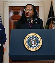 Judge Ketanji Brown Jackson speaks Friday in Cross Hall of the White House after President Biden introduced her as his nominee to the U.S. Supreme Court. Listening at right is Vice President Kamala Harris.