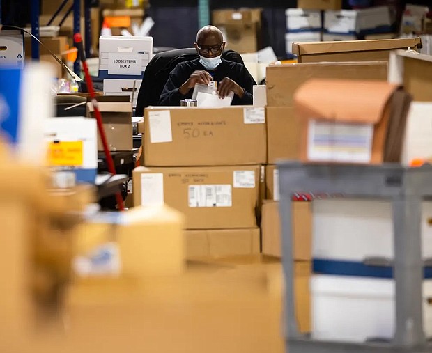 A Harris County Elections staff member at the Elections Technology Center warehouse in Houston on Tuesday. Credit: Annie Mulligan for The Texas Tribune