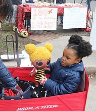 Harmony McKenzie, 4, makes her presence known as she attends the March to Fund Safe Schools last Saturday with her grandmother, Katina Harris, president of the Richmond Education Association. About 100 people walked from William Fox Elementary School on Hanover Avenue in The Fan to Monroe Park calling
for funding to upgrade or replace Virginia’s aging schools. Before the march, Ms. Harris paused to support a bake sale benefiting the Fox School community in the wake of the Feb. 11 fire that destroyed the building. The school opened in 1911. Many of those attending the march called for a new George Wythe High School to replace the decaying school building in South Side that opened in 1960. Harmony attends the pre-school at Mary Scott School in North Side.