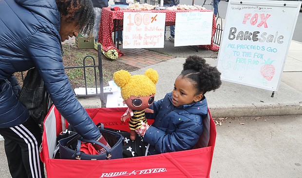 Harmony McKenzie, 4, makes her presence known as she attends the March to Fund Safe Schools last Saturday with her grandmother, Katina Harris, president of the Richmond Education Association. About 100 people walked from William Fox Elementary School on Hanover Avenue in The Fan to Monroe Park calling
for funding to upgrade or replace Virginia’s aging schools. Before the march, Ms. Harris paused to support a bake sale benefiting the Fox School community in the wake of the Feb. 11 fire that destroyed the building. The school opened in 1911. Many of those attending the march called for a new George Wythe High School to replace the decaying school building in South Side that opened in 1960. Harmony attends the pre-school at Mary Scott School in North Side.