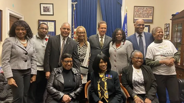 Back row from left to right: Edna W. Cummings (Colonel Ret.) (standing), Chris Goldson, Rodger Murphy Matthews (LTC Colonel Ret.), (son of Vashti Murphy Matthews and 6888 veteran), Natalie Durham (daughter of 6888 veteran Maybelle Campbell), Rep. Brian Higgins (D-NY) and Rep. Gwen Moore (D-WI), Stanley Early (son of 6888 Commander Charity Adams), Elizabeth Helm Frazier are just some of the people who helped the women of 6888th receive official honors. Front Row: Melody Campbell (daughter of Maybelle Campbell), Betty Schuler (daughter of Vashti Muphy Matthews) center front seated; Janice Martin (daughter of 6888 veteran Indiana Hunt-Martin) (Courtesy Photo)