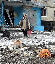 A woman carries a bucket following a shelling in Ukraine's second-biggest city of Kharkiv on March 7.
Mandatory Credit:	Sergey Bobok/AFP/Getty Images