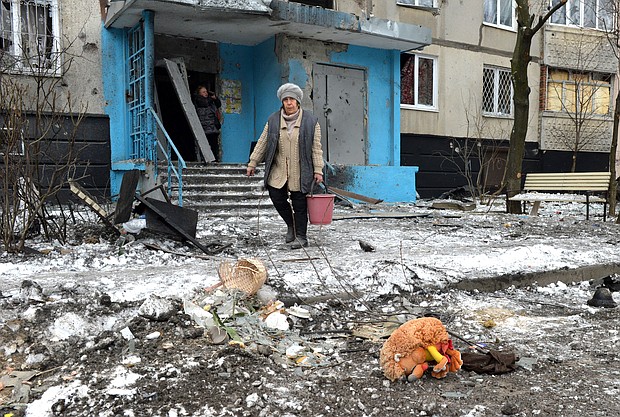 A woman carries a bucket following a shelling in Ukraine's second-biggest city of Kharkiv on March 7.
Mandatory Credit:	Sergey Bobok/AFP/Getty Images
