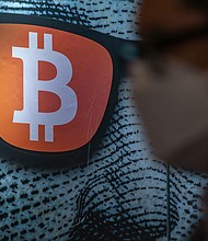 Pedestrians walk past a display of cryptocurrency Bitcoin on February 15, 2022 in Hong Kong, China.
Mandatory Credit:	Anthony Kwan/Getty Images