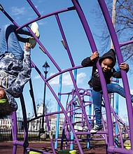 Deserea Goodwyn, 15, left, shows her 4-year-old niece, Eva Crawley, the art of climbing
on playground equipment recently at Abner Clay Park in Jackson Ward. The two were at
the park with Kira Crawley, Eva’s mom and Deserea’s sister.