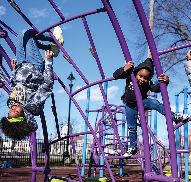 Deserea Goodwyn, 15, left, shows her 4-year-old niece, Eva Crawley, the art of climbing
on playground equipment recently at Abner Clay Park in Jackson Ward. The two were at
the park with Kira Crawley, Eva’s mom and Deserea’s sister.