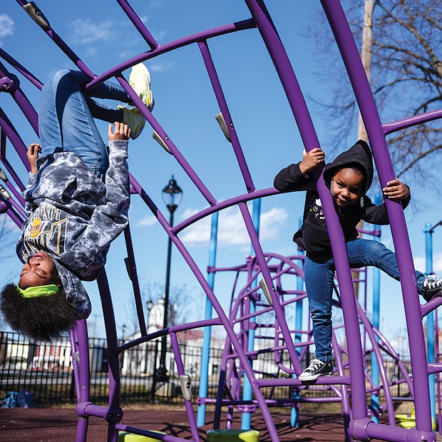 Deserea Goodwyn, 15, left, shows her 4-year-old niece, Eva Crawley, the art of climbing
on playground equipment recently at Abner Clay Park in Jackson Ward. The two were at
the park with Kira Crawley, Eva’s mom and Deserea’s sister.