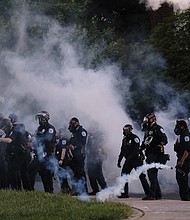 In this file photo, Richmond Police release tear gas on demonstrators at the Lee Monument on Monument Avenue on June 1, 2020, during the third day of local protests against police brutality and racial injustice following the murder of George Floyd at the hands of Minneapolis Police on May 28, 2020. The crowd that included families with children was tear-gassed about 20 minutes ahead of that day’s 8 p.m. curfew. Then-Police Chief William Smith, who apologized along with Mayor Levar M. Stoney the next day, later resigned and promised to discipline the officers. Six people later filed a lawsuit, which was settled by the City of Richmond in February. The terms were not disclosed.