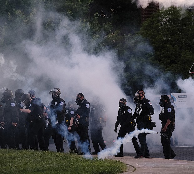 In this file photo, Richmond Police release tear gas on demonstrators at the Lee Monument on Monument Avenue on June 1, 2020, during the third day of local protests against police brutality and racial injustice following the murder of George Floyd at the hands of Minneapolis Police on May 28, 2020. The crowd that included families with children was tear-gassed about 20 minutes ahead of that day’s 8 p.m. curfew. Then-Police Chief William Smith, who apologized along with Mayor Levar M. Stoney the next day, later resigned and promised to discipline the officers. Six people later filed a lawsuit, which was settled by the City of Richmond in February. The terms were not disclosed.