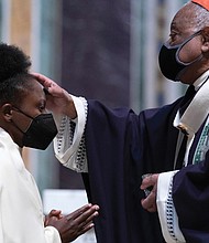 Cardinal Wilton Gregory, the archbishop of Washington, places ashes on the forehead of a parishioner during Ash Wednesday Mass last week at Saint Matthew the Apostle Cathedral in Washington. Ash Wednesday marks the beginning of Lent.