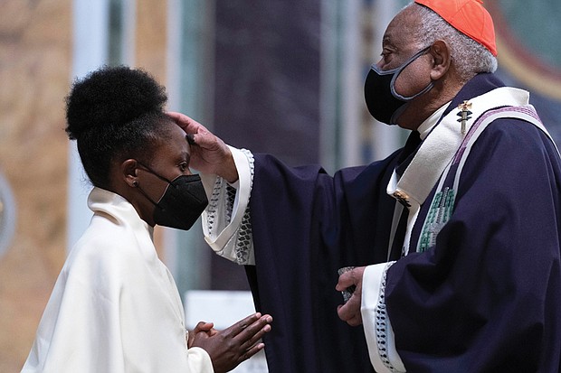 Cardinal Wilton Gregory, the archbishop of Washington, places ashes on the forehead of a parishioner during Ash Wednesday Mass last week at Saint Matthew the Apostle Cathedral in Washington. Ash Wednesday marks the beginning of Lent.