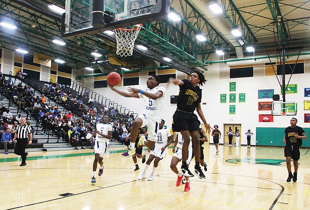 John Marshall High School’s Reggie Robertson, No. 5, leaps to make the basket during Monday night’s semifinal game against Greensville High School. Robertson, a senior, scored 14 points during the game played at Huguenot High School, helping the Justices to their 92-53 victory and advancement to the state championship game on Saturday, March 12, at the Siegel Center.