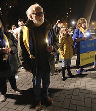 Richmonders pray for peace and the people of Ukraine at a vigil held March 3 at Monroe Park by the Virginia Commonwealth University campus. The vigil was organized by the Rev. Joe Ellison Jr., the chaplain for Virginia Union University’s athletic teams, who spoke during the candlelight event. Various pastors and community members attended the vigil in support, including representatives from the offices of Gov. Glenn A. Youngkin and Mayor Levar M. Stoney.