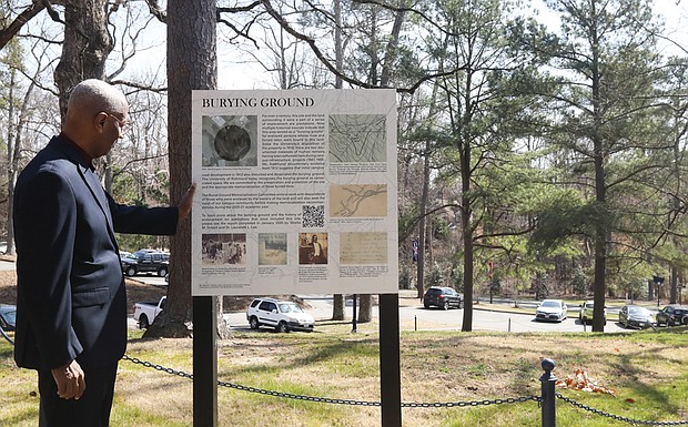 Congressman A. Donald McEachin, sponsor of a bipartisan bill to provide $3 million in federal funding for historic Black cemeteries, views the burial site for an unknown number of enslaved people located near Westhampton Lake on what is now the campus of the University of Richmond. The land, acquired by the university in 1910, had been part of a plantation.