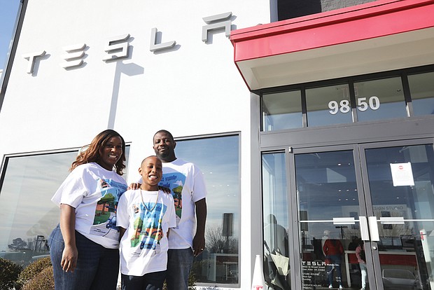 Uziah Smith-Bashir, 8, visits the Tesla dealership on West Broad Street in Glen Allen with his parents, Nafeesa Bashir-James and Torrey James. The second-grader at Thales Academy is enamored with the electric vehicles and the “falcon-wing” doors that open like bird’s wings and has written a book about it that will be launched March 26. Far right, Uziah checks out his favorite Tesla model, Model X, and its “falcon-wing” doors.